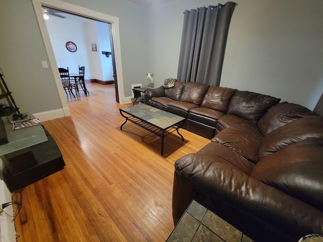 living room featuring baseboards and light wood finished floors