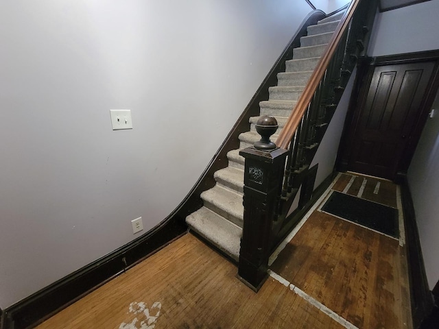 staircase featuring wood finished floors