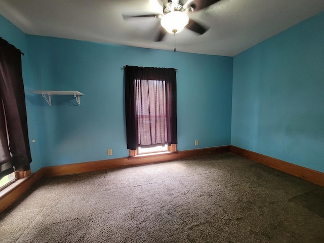 carpeted empty room with baseboards and ceiling fan