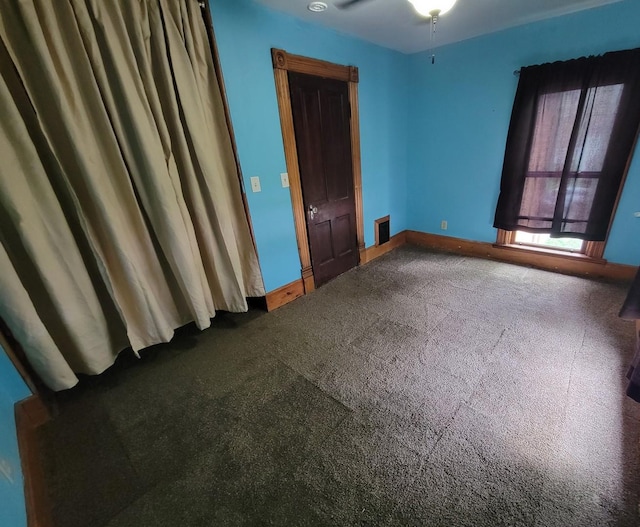 unfurnished bedroom with carpet flooring, baseboards, and visible vents