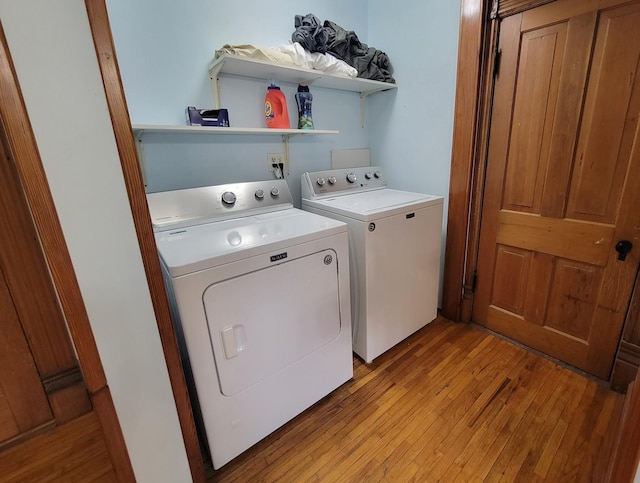 laundry area featuring independent washer and dryer and light wood-style flooring