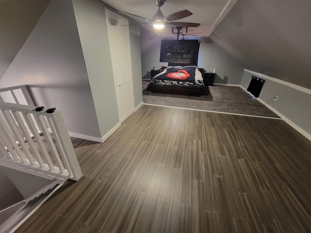 interior space featuring baseboards, vaulted ceiling, ceiling fan, and wood finished floors