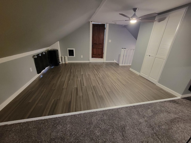 bonus room featuring ceiling fan, lofted ceiling, baseboards, and wood finished floors