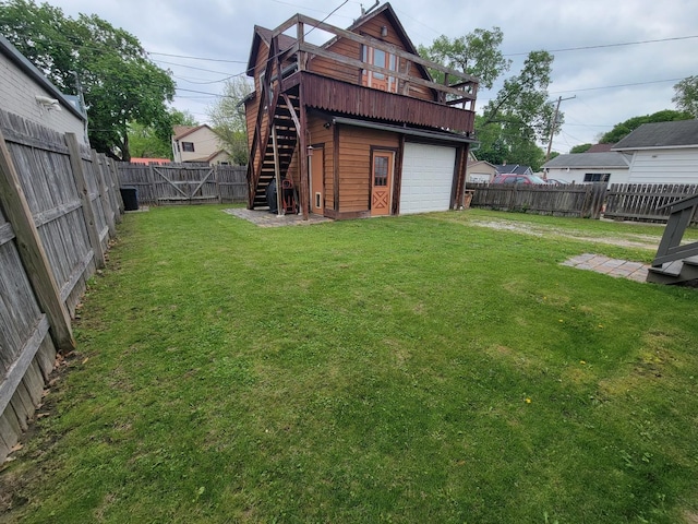 exterior space with a deck, stairway, a garage, and a fenced backyard