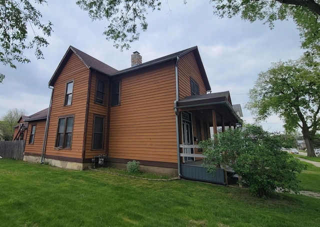 view of property exterior featuring a yard and a chimney