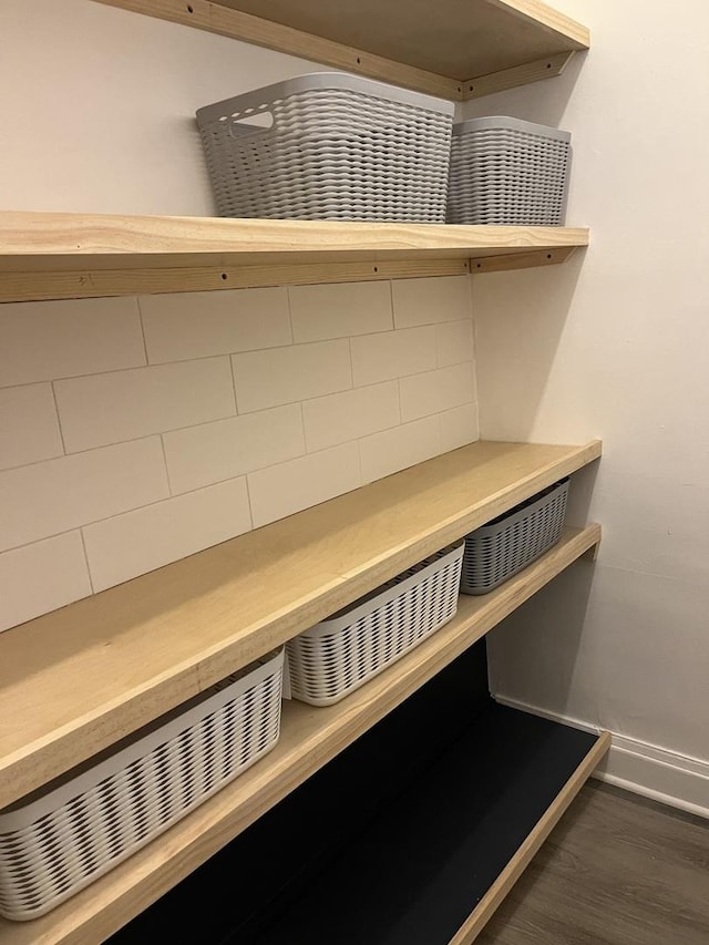 interior details featuring baseboards and wood finished floors