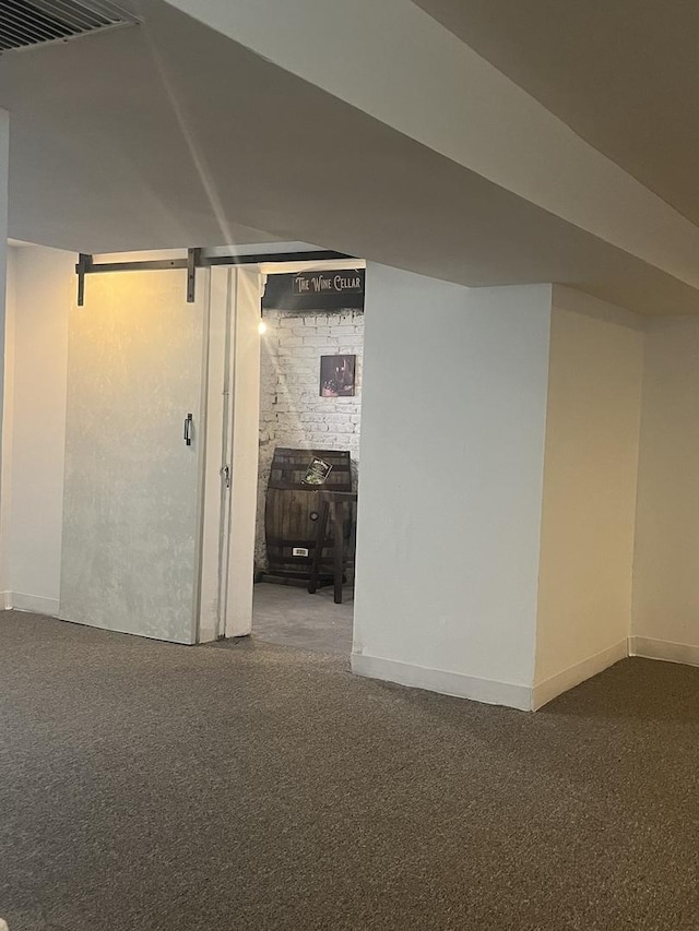 finished basement featuring baseboards and carpet
