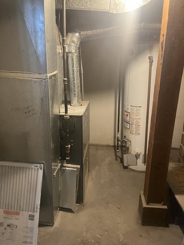 utility room featuring water heater