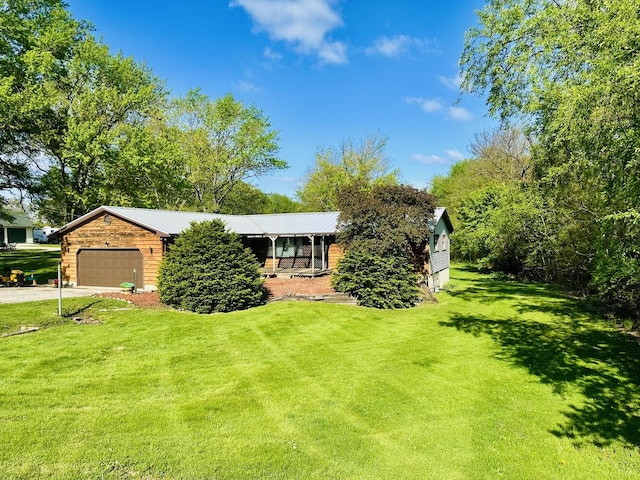 1310 E 15th Rd, Streator, IL 61364 - view of front facade featuring driveway, a front lawn, a garage, and metal roof