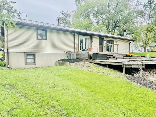 1310 E 15th Rd, Streator, IL 61364 - back of property with metal roof, a deck, a lawn, and central AC