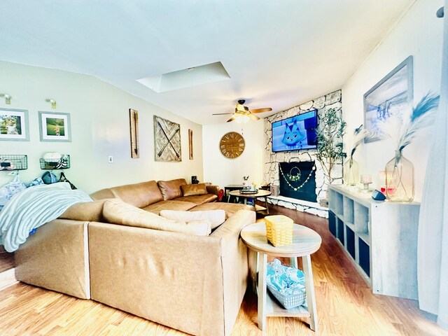 1310 E 15th Rd, Streator, IL 61364 - living room featuring a ceiling fan, wood finished floors, a skylight, and a fireplace