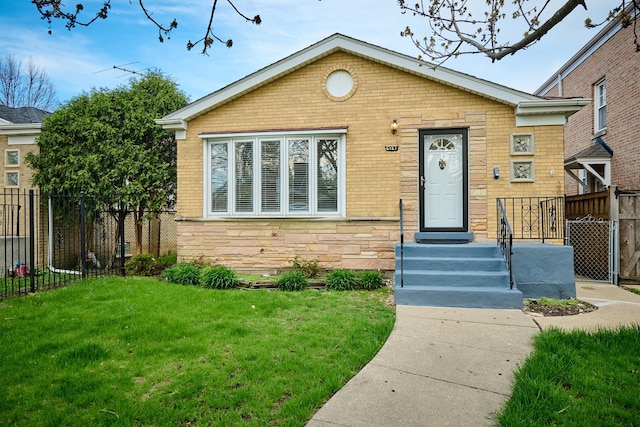 bungalow-style house featuring brick siding, fence, stone siding, and a front yard