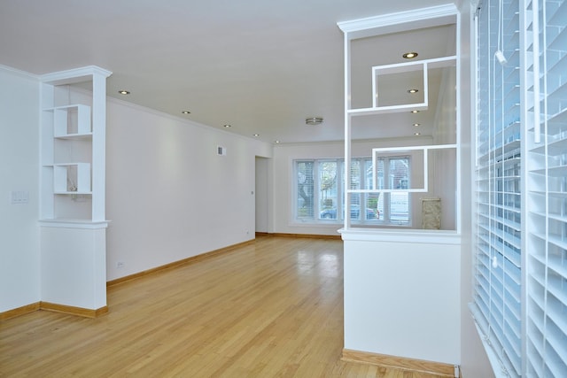 unfurnished living room with crown molding, recessed lighting, baseboards, and wood finished floors