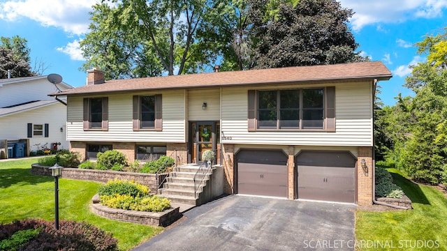 6540 Terrace Dr, Downers Grove, IL 60516 - split foyer home featuring an attached garage, brick siding, asphalt driveway, a front yard, and a chimney
