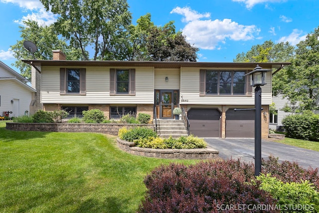 6540 Terrace Dr, Downers Grove, IL 60516 - split foyer home featuring asphalt driveway, a garage, a chimney, a front yard, and brick siding