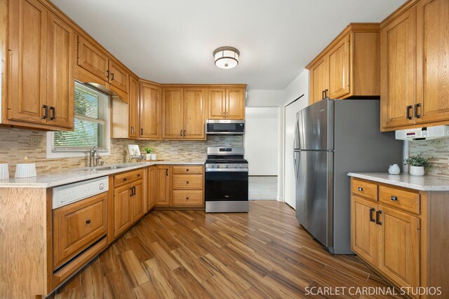 6540 Terrace Dr, Downers Grove, IL 60516 - kitchen featuring appliances with stainless steel finishes, dark wood-type flooring, light countertops, a sink, and tasteful backsplash