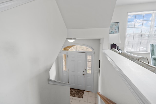 foyer featuring vaulted ceiling and light tile patterned floors