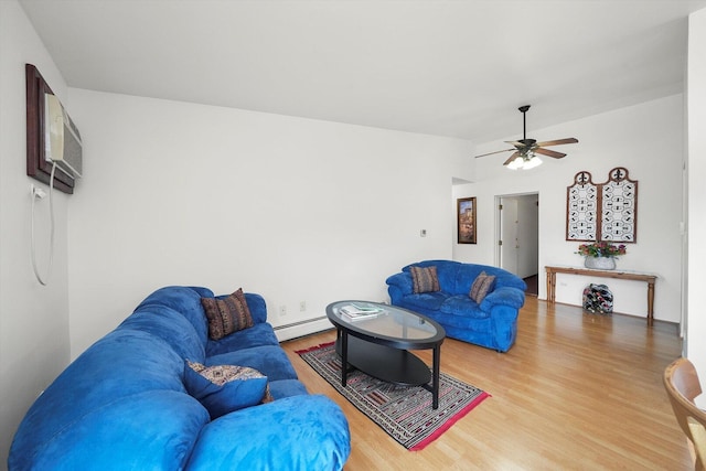 living room with a wall mounted AC, a ceiling fan, baseboard heating, and wood finished floors