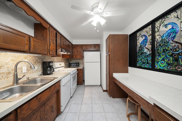 kitchen featuring a sink, white appliances, ceiling fan, backsplash, and under cabinet range hood