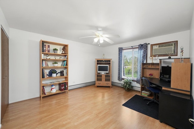 office area featuring a wall mounted air conditioner, wood finished floors, ceiling fan, a baseboard radiator, and baseboards