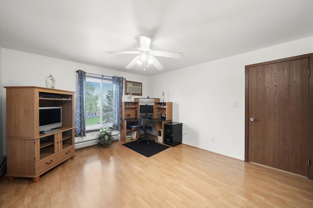 interior space featuring a baseboard radiator, a wall unit AC, a ceiling fan, and wood finished floors