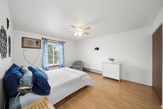 bedroom with ceiling fan, a wall mounted air conditioner, light wood-style flooring, and baseboard heating