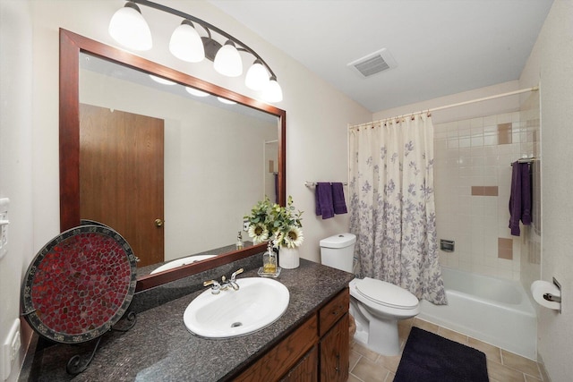 full bathroom featuring toilet, vanity, shower / tub combo with curtain, visible vents, and tile patterned flooring
