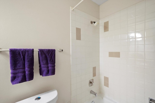 bathroom with toilet and bathtub / shower combination
