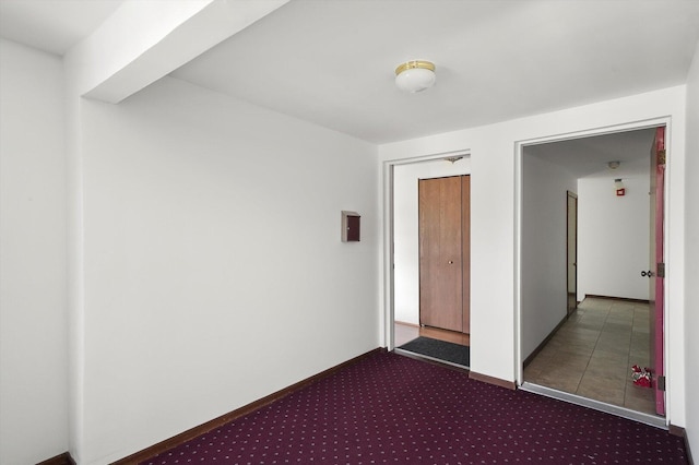 unfurnished bedroom featuring carpet, a closet, and baseboards