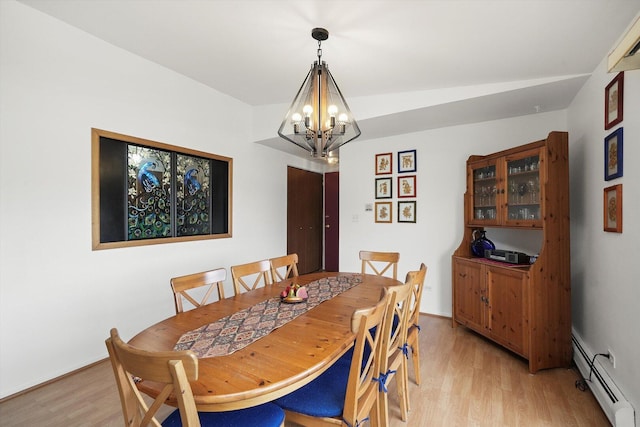 dining space with light wood-style flooring, a notable chandelier, and baseboard heating