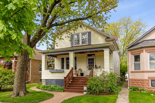 bungalow-style home with covered porch and stairs