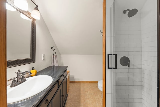 bathroom featuring a shower stall, vaulted ceiling, vanity, and toilet