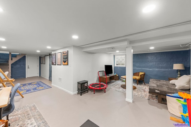 below grade area featuring stairway, baseboards, and recessed lighting