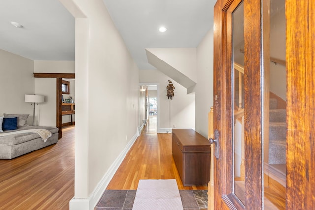 hallway with wood finished floors, recessed lighting, and baseboards