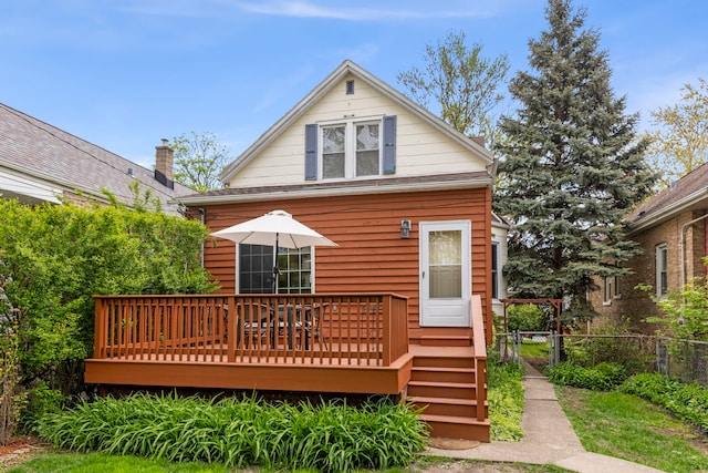 back of property featuring fence and a deck
