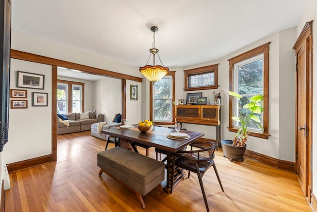 dining room featuring baseboards and light wood finished floors
