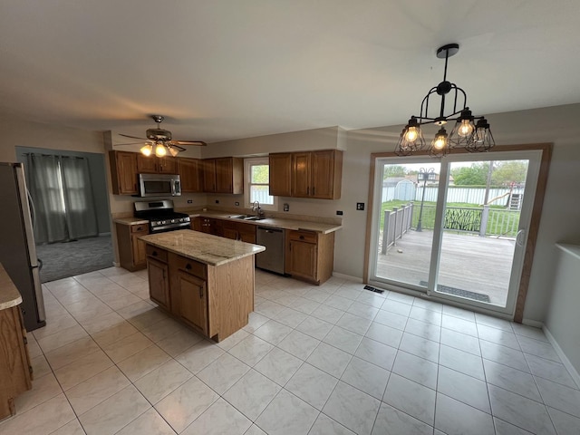17242 W Rich Ct, Elwood, IL 60421 - kitchen with a center island, a sink, baseboards, appliances with stainless steel finishes, and light tile patterned flooring