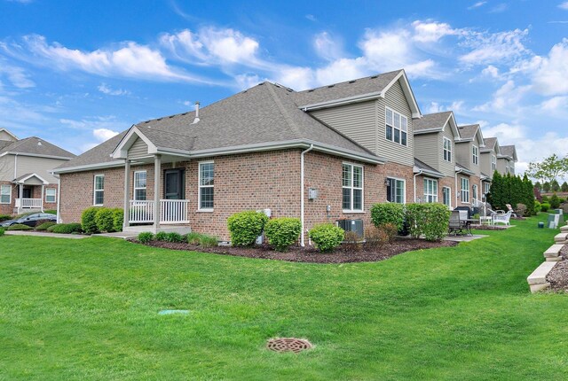11130 Alpine Ln, Orland Park, IL 60467 - view of side of property featuring brick siding, cooling unit, roof with shingles, and a yard