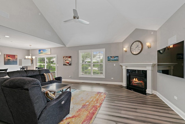 11130 Alpine Ln, Orland Park, IL 60467 - living area with vaulted ceiling, a chandelier, wood finished floors, ceiling fan, and a fireplace with flush hearth