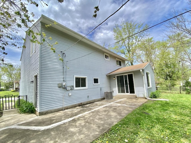 rear view of house featuring a patio and central AC