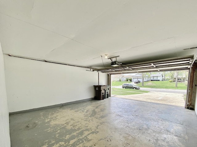 garage with a garage door opener and baseboards