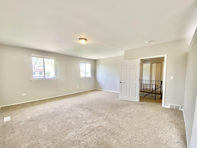 carpeted spare room with baseboards