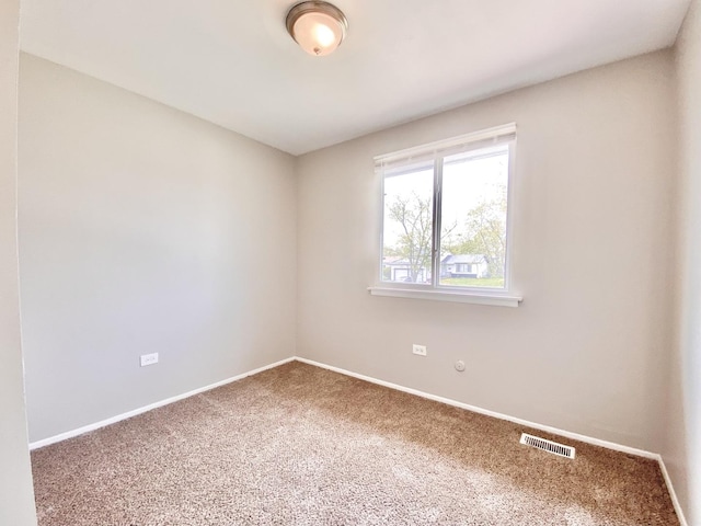 unfurnished room with carpet floors and baseboards