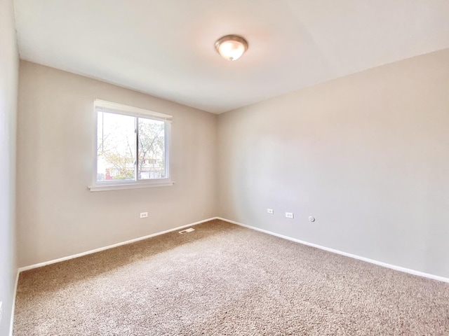 carpeted empty room with baseboards