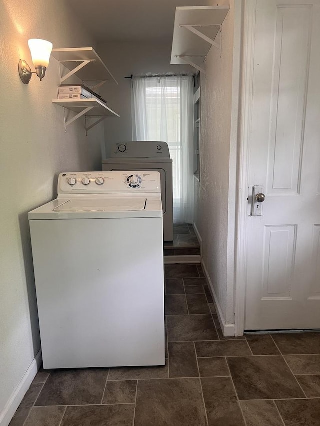 laundry room featuring baseboards, laundry area, and washer / clothes dryer