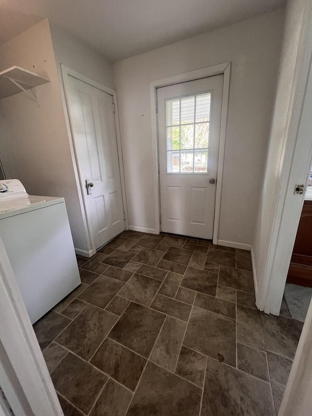 laundry room featuring laundry area, washer / dryer, and baseboards