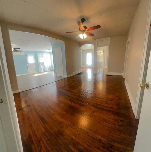 unfurnished room with plenty of natural light, a ceiling fan, and hardwood / wood-style floors