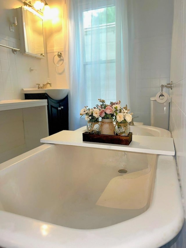 bathroom featuring tile walls and vanity