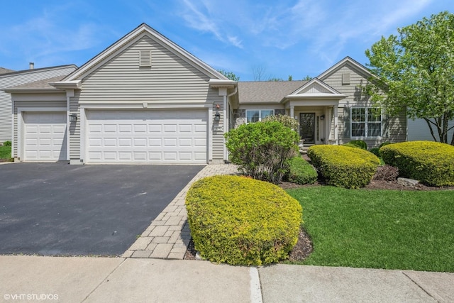 14112 Redmond Dr, Huntley, IL 60142 - view of front of house featuring a front yard, aphalt driveway, and an attached garage