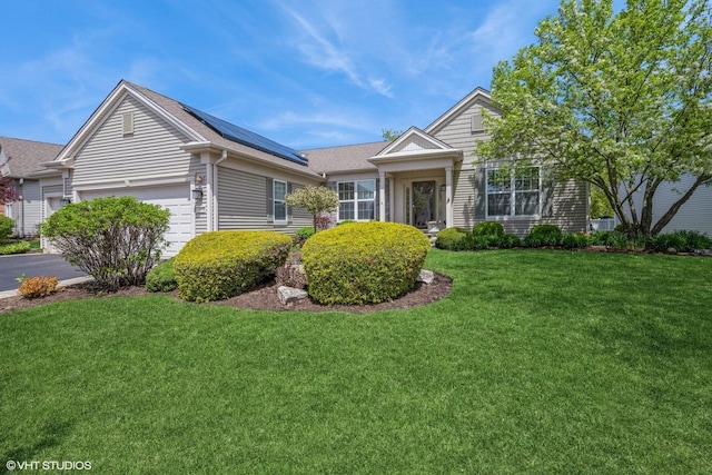 14112 Redmond Dr, Huntley, IL 60142 - single story home featuring roof mounted solar panels, an attached garage, and a front yard